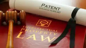 Gavel on intellectual property law book with a patent certificate.