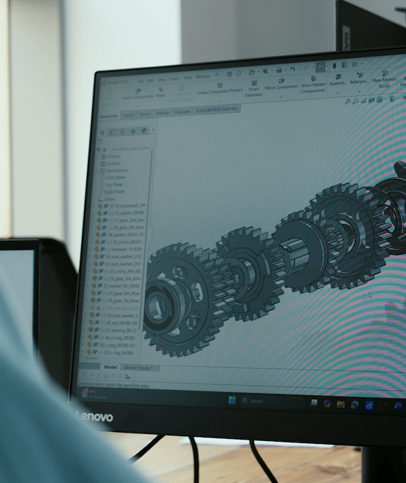 Computer screen displaying a 3D gear assembly design in CAD software.