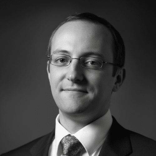 Professional man in glasses and suit, monochrome portrait.